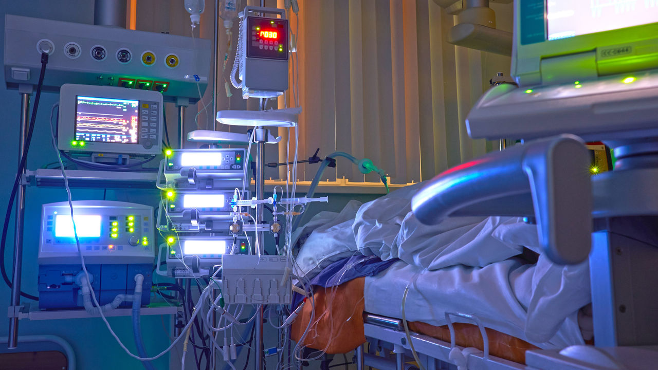 Glowing monitors in intensive care department. Nigth shift at icu, patient in critical state.