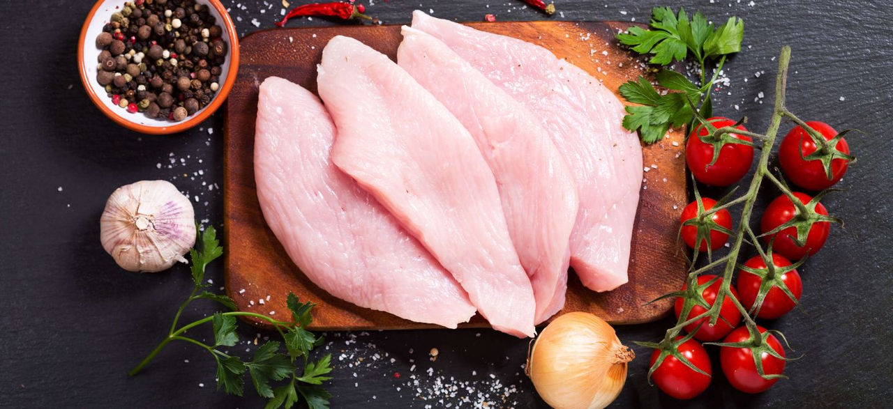 Cuts of raw turkey on a cutting board